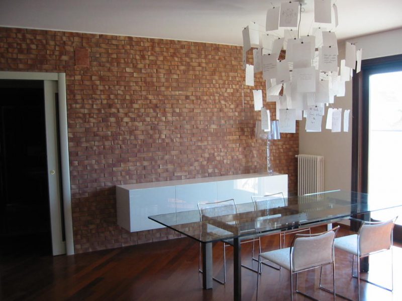 Brick wall and suspended LAGO cabinet | Ingo Maurer suspension lamp