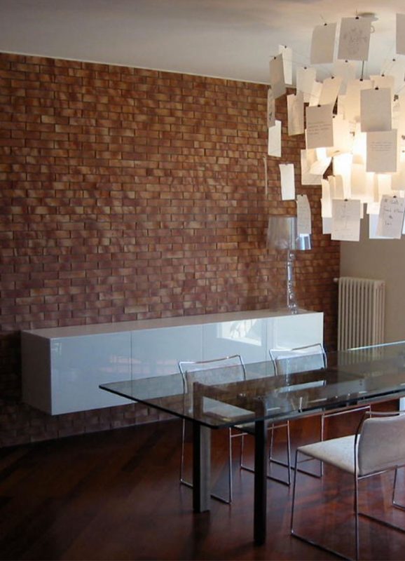Brick wall and suspended cabinet with white glass doors
