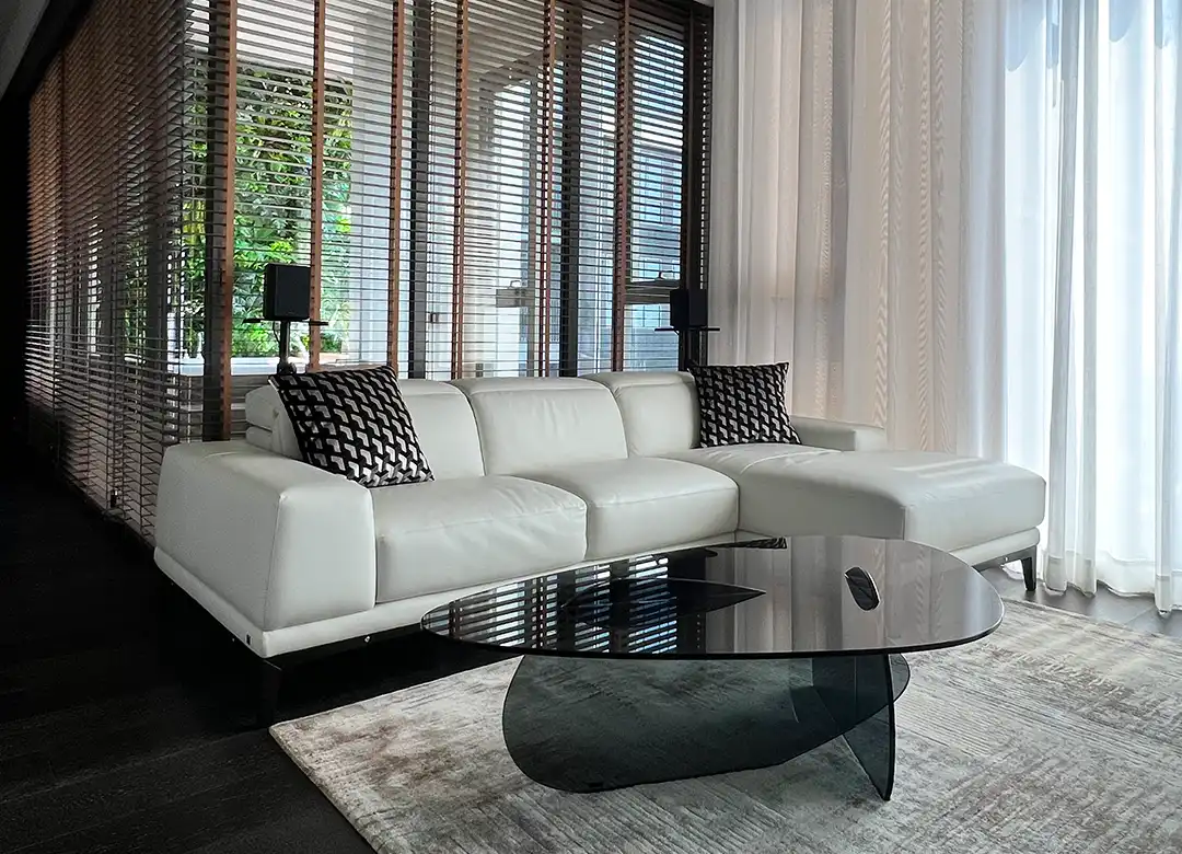 Tonelli KAT glass coffee table designed by Karim Rashid paired with white leather Natuzzi sectional sofa at The Forestias Bang Na penthouse by Elementi Interiors