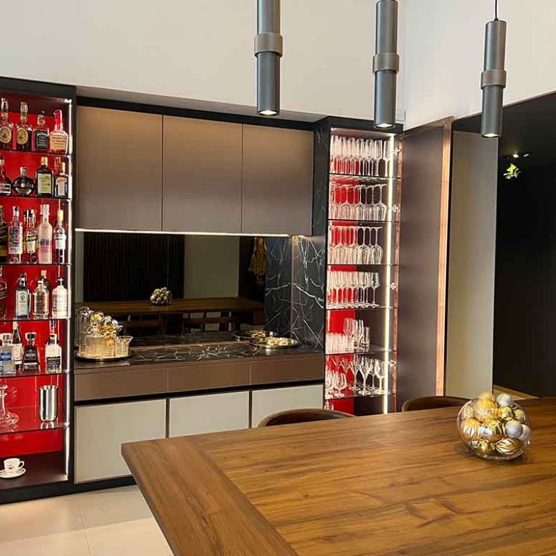 Custom-made bar cabinet. Bronze metallic doors and italian ceramic stone with spacious shelves for liquors and spirits.