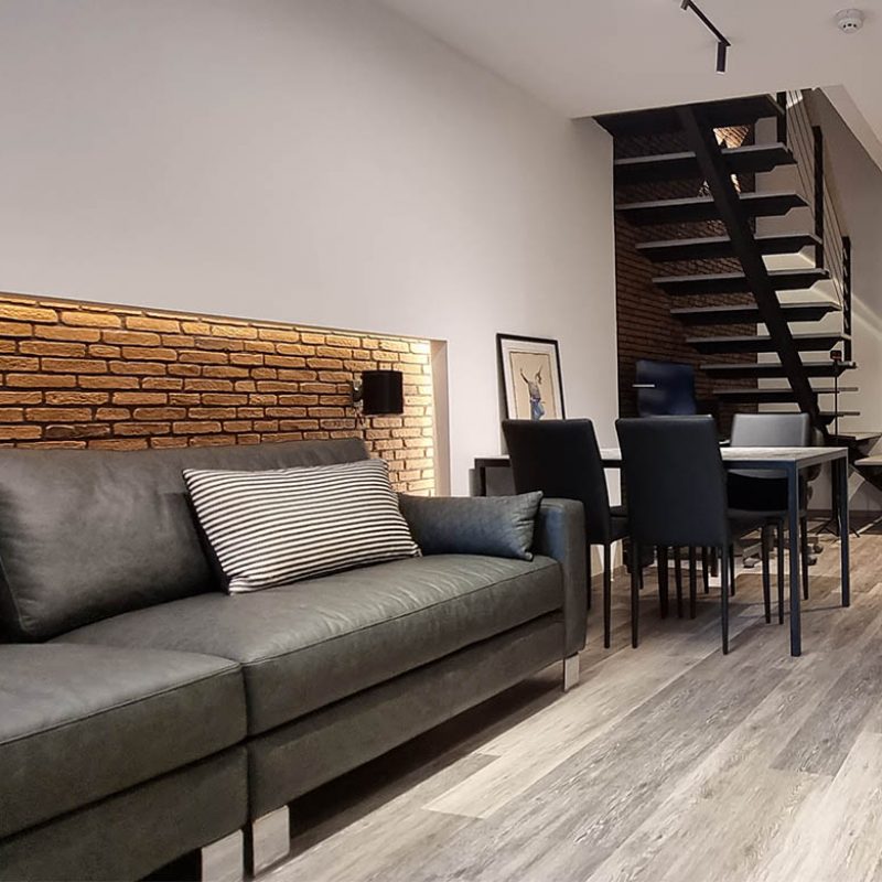 Brick wall | Leather sofa | Vinyl flooring
